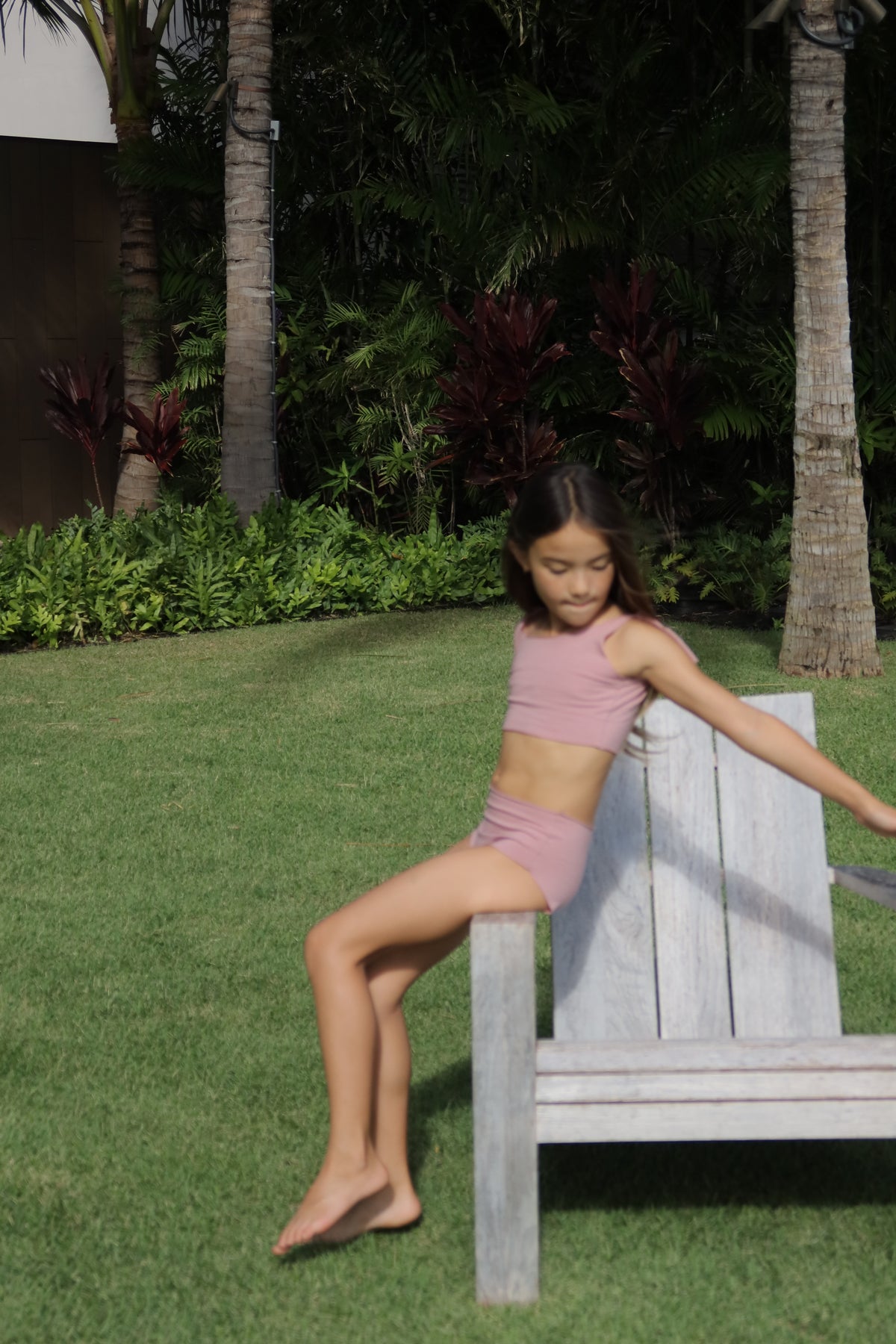 Girl moving in an olive WANINI swimsuit during an outdoor wear test