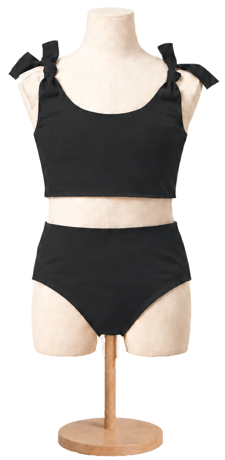 Matching girls' cotton swimsuit in Black on a child dress form