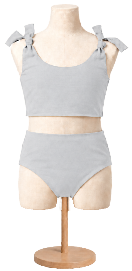 Matching girls' cotton swimsuit in Gray on a child dress form