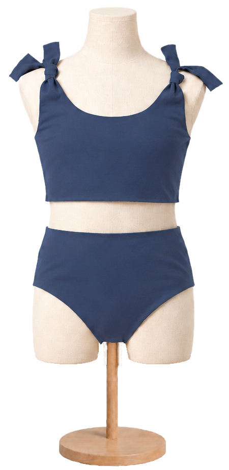 Matching girls' cotton swimsuit in Navy on a child dress form