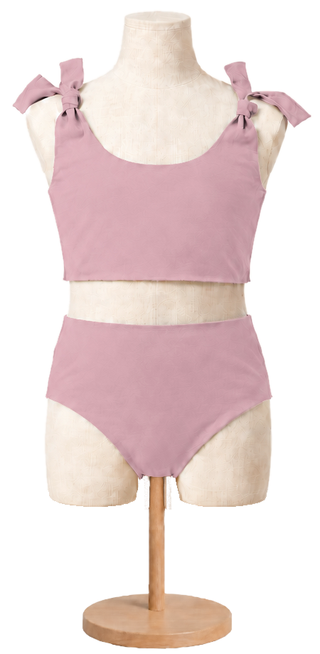 Matching girls' cotton swimsuit in Rose on a child dress form